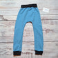 Lovingly handmade harem joggers, in sky blue cotton French terry and black cotton ribbing. Shown from the rear.