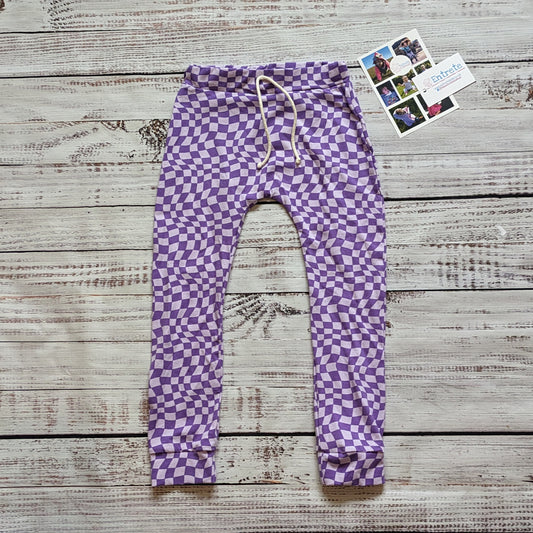 The fab purple trippy checked harem joggers. Handmade from soft and stretchy cotton jersey, with an elasticated waist and roll-able ankle cuffs.