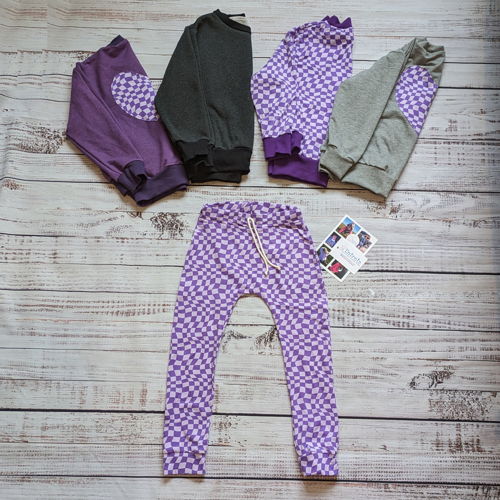 Fun purple trippy checked heart sweatshirts. Handmade in your choice of cotton French Terry colour, with matching cotton ribbing and a purple trippy checked heart on the back. Shown with matching harem joggers.