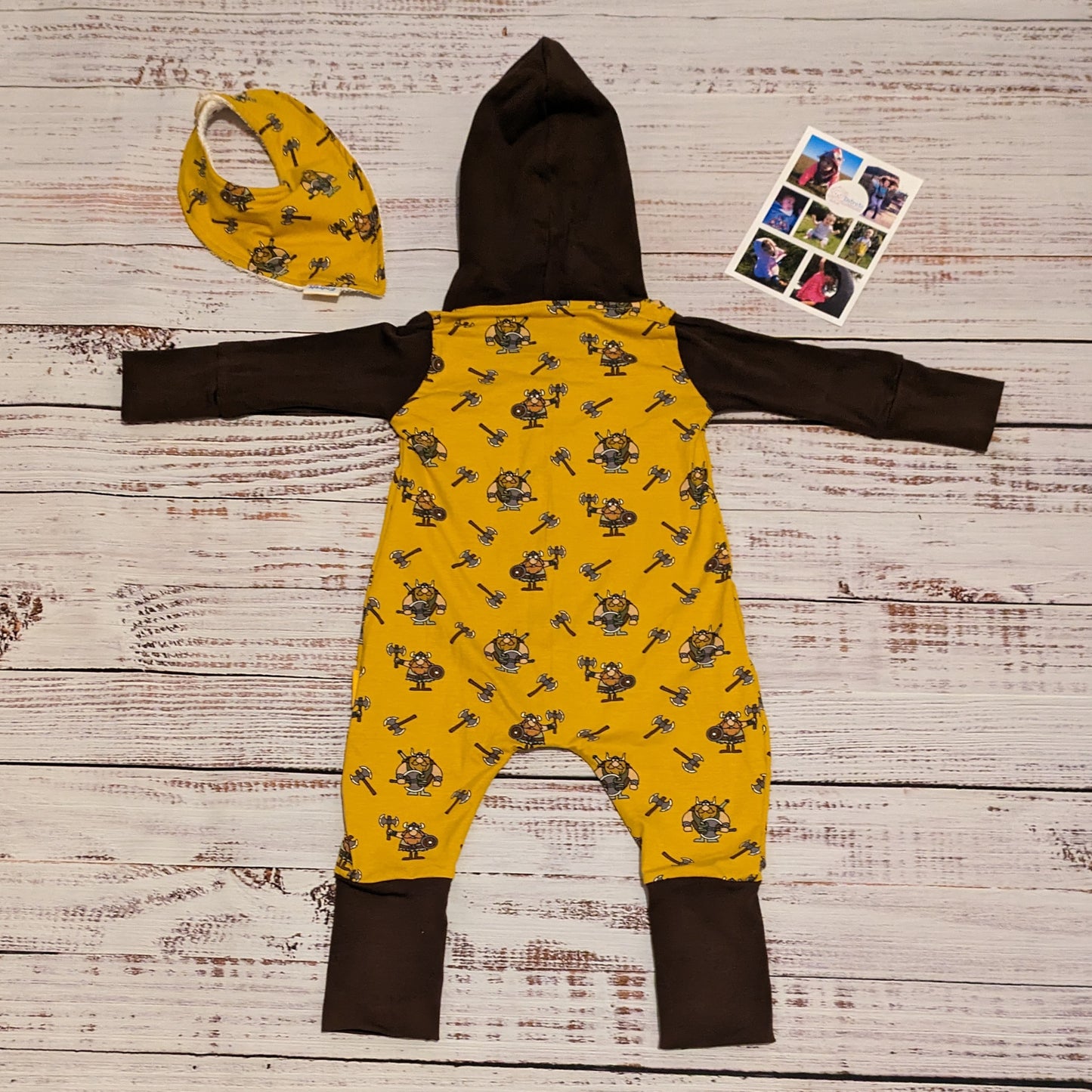 The fun and adorable mustard Vikings, hooded popper romper. Shown with long sleeves and the back, with a matching bamboo bib. Lovingly handmade in mustard Vikings and chocolate cotton jersey's.