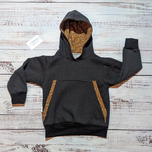 The understated and stylish camel leopard print children's hoodie. Handmade with camel leopard print organic cotton jersey, charcoal cotton French terry and cotton ribbing.