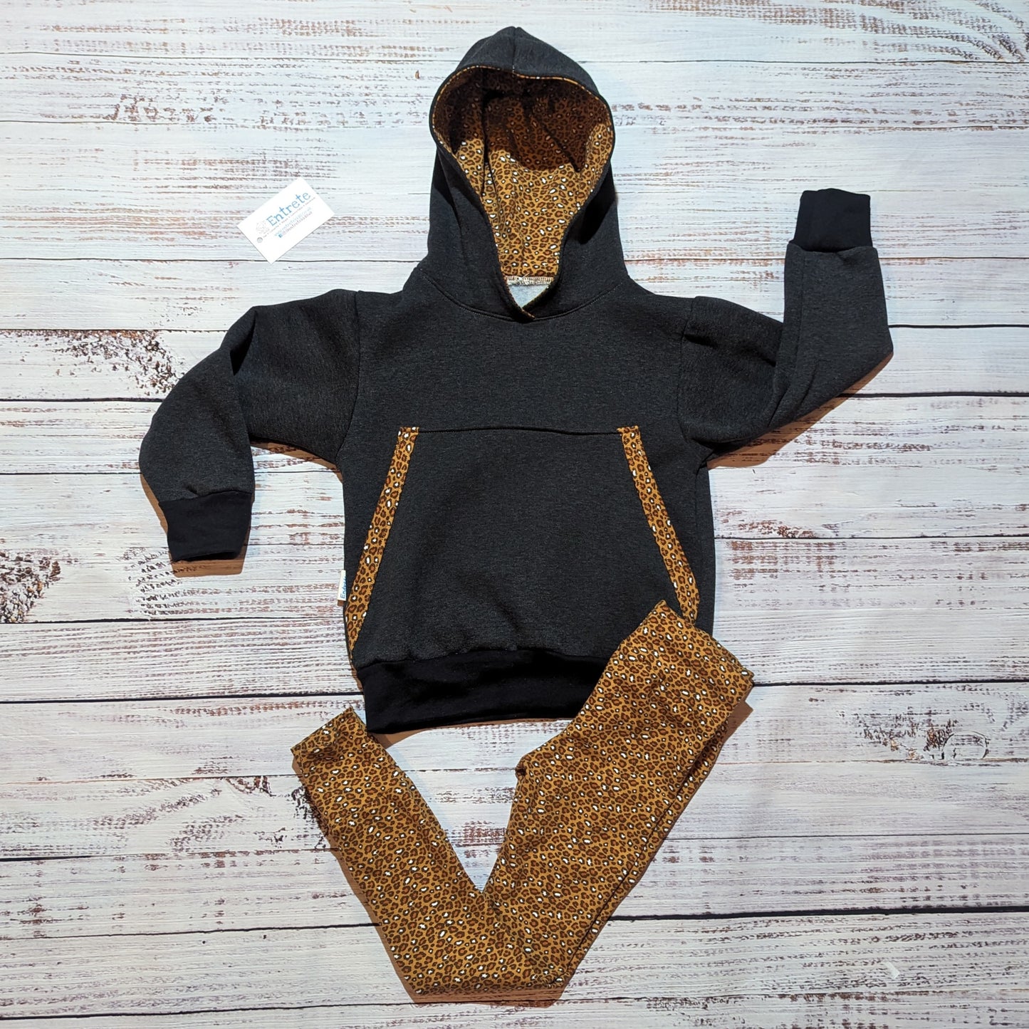 The understated and stylish camel leopard print children's hoodie. Handmade with camel leopard print organic cotton jersey, charcoal cotton French terry and cotton ribbing. Shown with matching leggings , that accentuate the look.