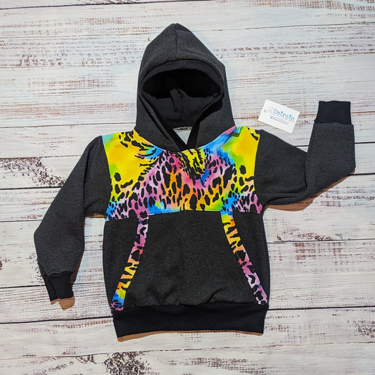 Front view of the vibrant neon animal print hoodie. Featuring animal print detailing around the front pocket, charcoal cotton French terry and cotton ribbing.