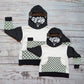 A stunning hoodie with an eclectic mix of colours and patterns. Handmade using neon animal print, neon leopard print, animal hearts, mint checked, white and charcoal cotton French terry and cotton ribbing. Shown in a Mama and Mini set.