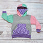 The fabulous purple trippy checked hoodie. Handmade using purple trippy checked cotton jersey, mint, pink and grey cotton French terry and purple cotton ribbing. With a purple checked front pocket.