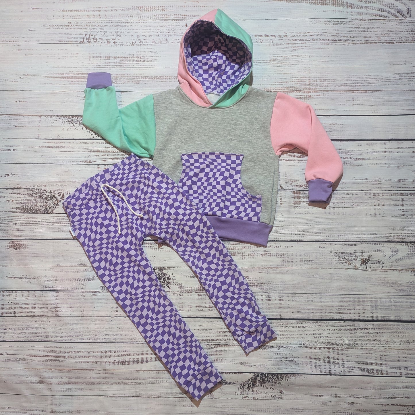 The fabulous purple trippy checked hoodie. Handmade using purple trippy checked cotton jersey, mint, pink and grey cotton French terry and purple cotton ribbing. Shown with purple trippy checked harem joggers.