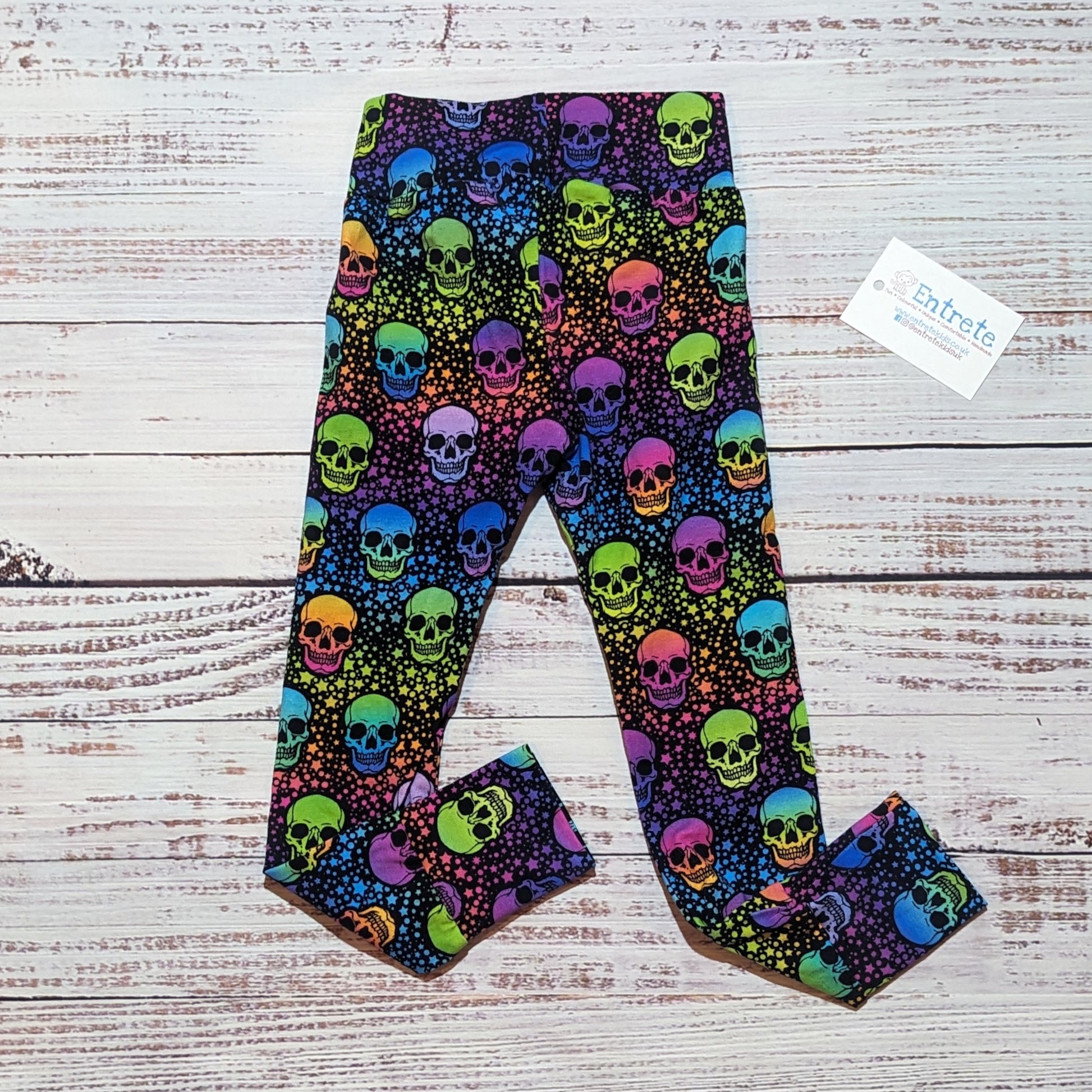 Women's colourful neon skulls leggings, shown folded. Handmade from soft, stretchy cotton jersey.