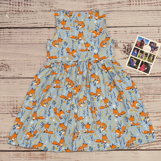 The fantastic Sky blue foxes girls dress, shown as a sleeveless dress. Handmade using soft and comfy sky blue foxes cotton jersey.