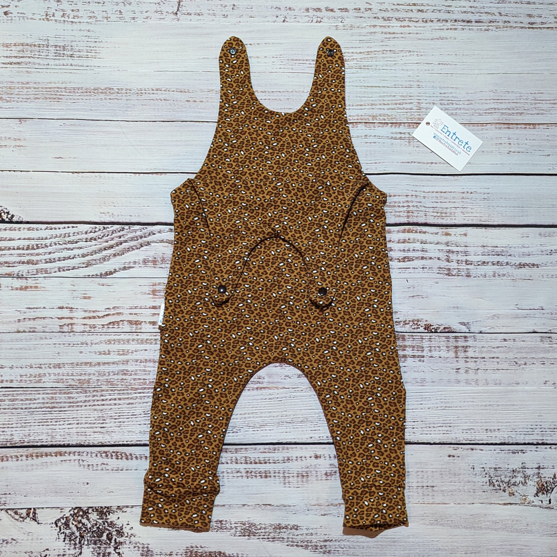 The stylish camel leopard print sleeveless romper. Handmade using soft and comfortable organic cotton jersey. Shown with the shoulder popper entry open.
