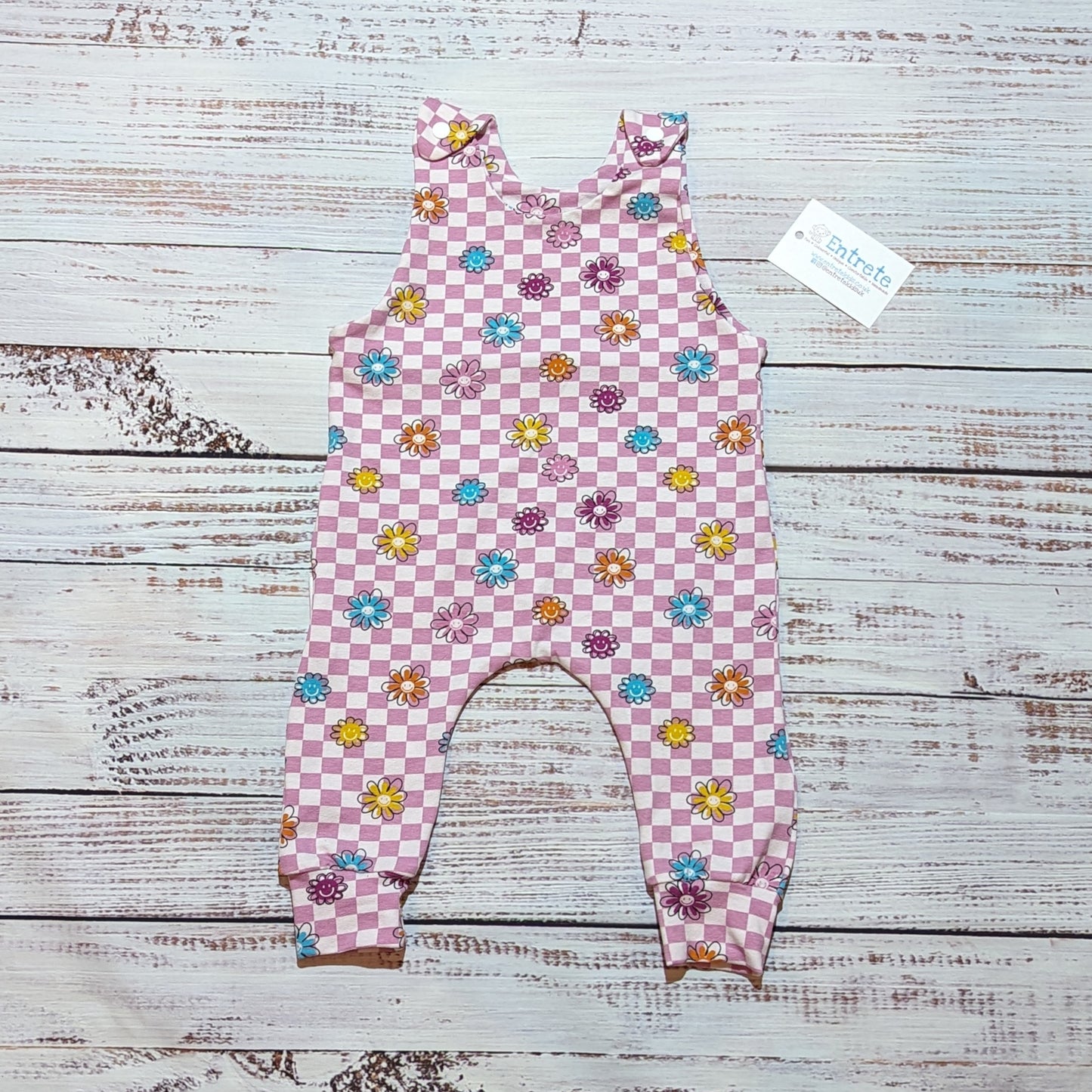Pink checked happy flowers sleeveless romper. With shoulder popper entry and roll-able ankle cuffs. Handmade in soft and comfy cotton jersey.