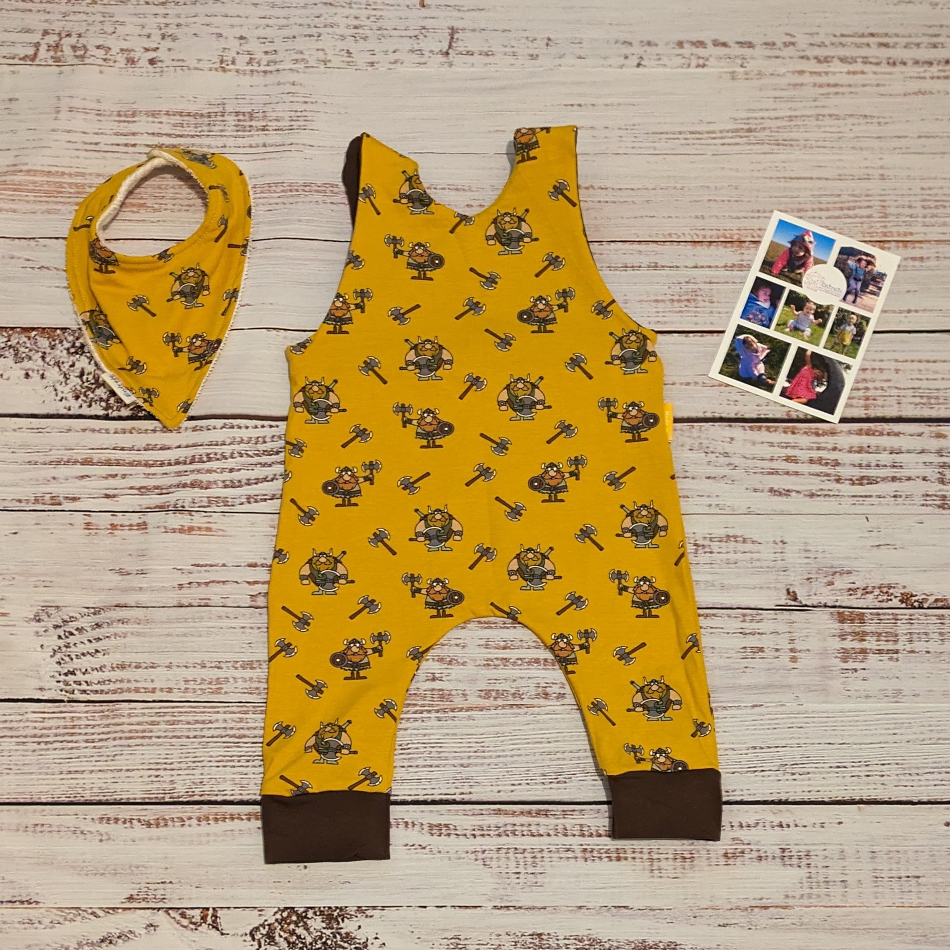 The soft, comfy and fun mustard Vikings sleeveless romper. Shown from the back with a matching bamboo bib. Lovingly handmade using mustard Vikings and chocolate cotton jersey's.