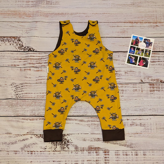 The soft, comfy and fun mustard Vikings sleeveless romper. Shown from the front. Lovingly handmade using mustard Vikings and chocolate cotton jersey's.