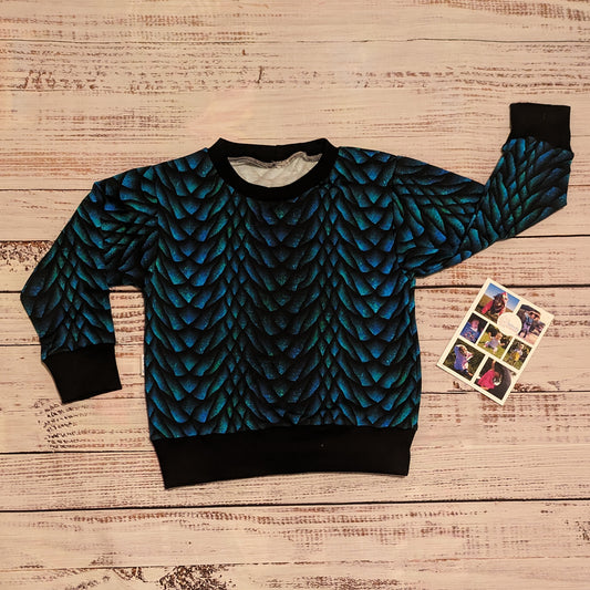 The gorgeous glimmering dragon scales sweatshirt. Handmade using dragon scales cotton French terry and black cotton ribbing. Showing the long sleeve version.