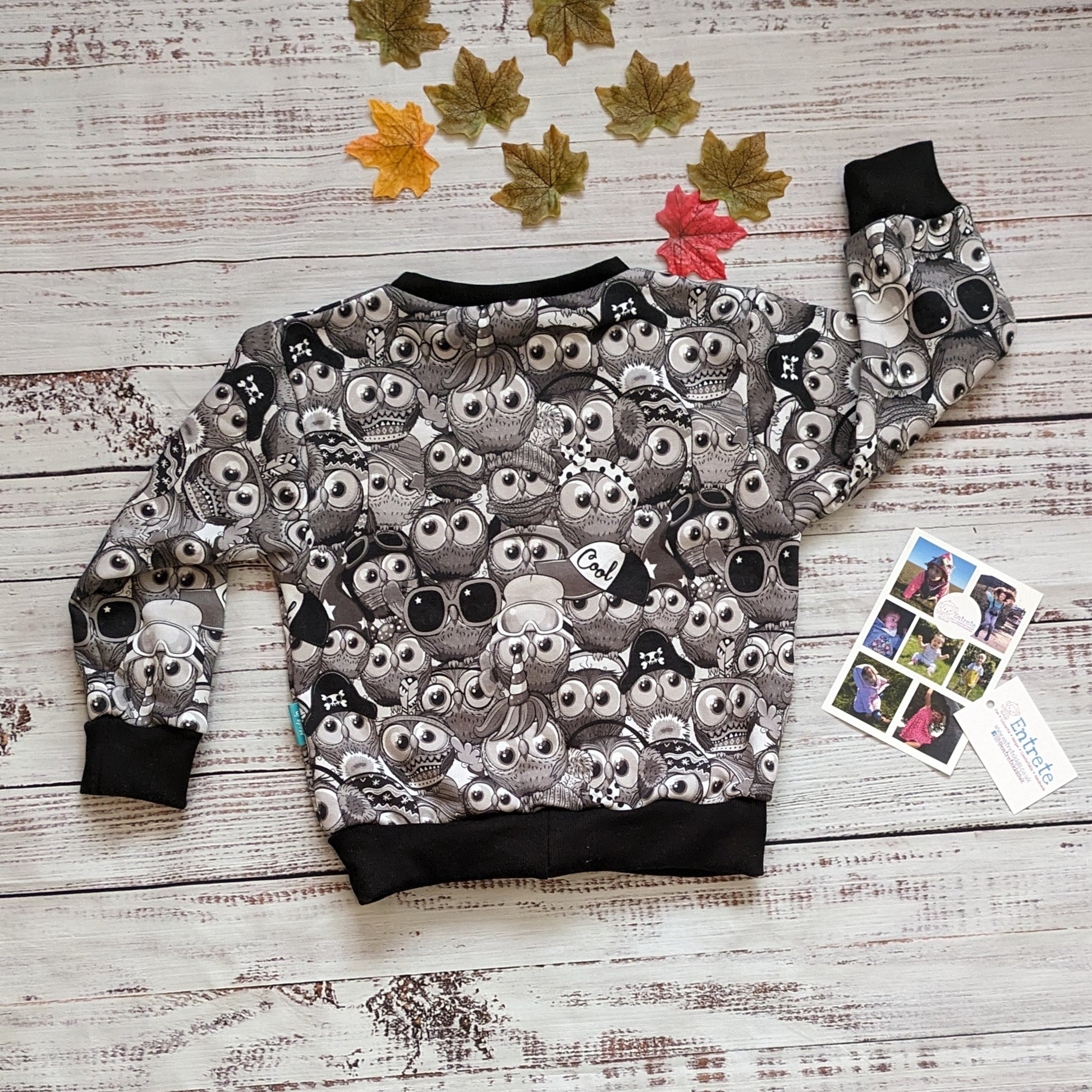 Fun, black and white cartoon owl sweatshirt. Handmade using warm monochrome owls cotton sweatshirt fleece and black cotton ribbing. Shown from the rear.