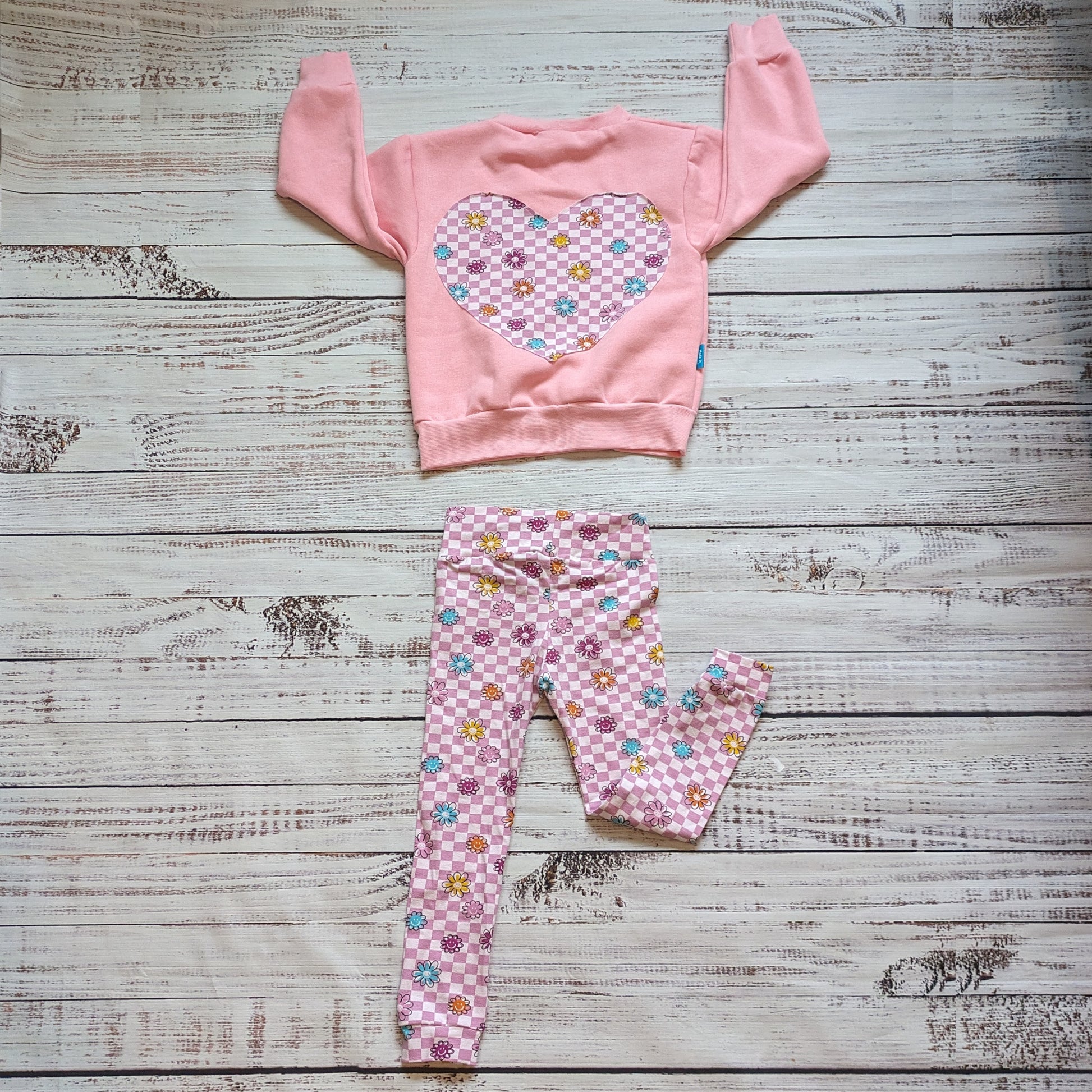 The pink checked happy flowers leggings, shown with a matching sweatshirt.
