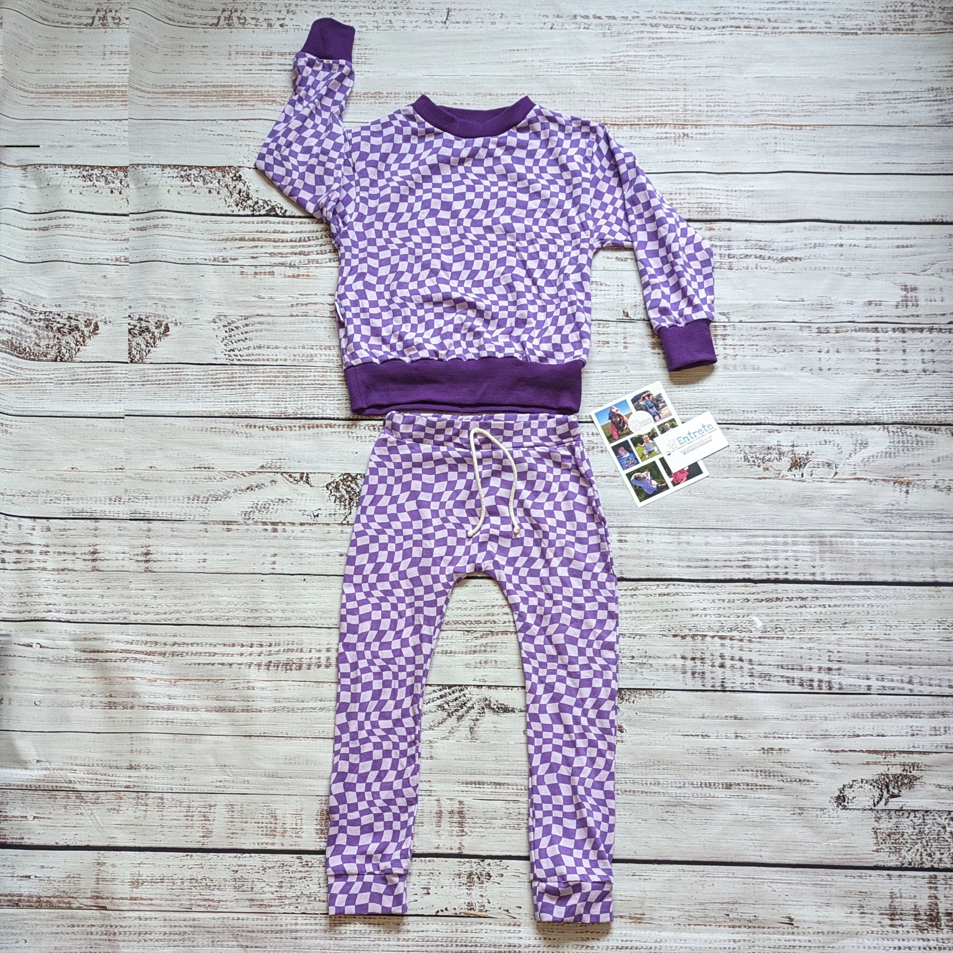 Warped purple trippy checked sweatshirt. Handmade using soft and comfy cotton jersey and cotton ribbing. Shown with a pair of purple trippy checked harem joggers.
