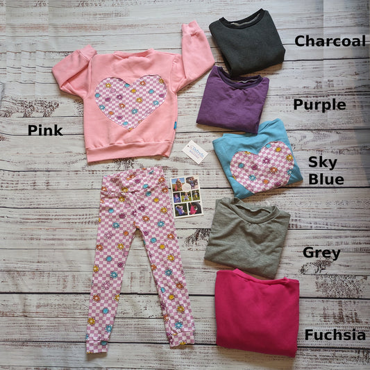 Pink Checked Happy Flowers Heart Sweatshirts Shown with a pair of matching leggings. Demonstrating the available colour choices.