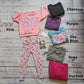 Pink Checked Happy Flowers Heart Sweatshirts Shown with a pair of matching leggings. Demonstrating the available colour choices.