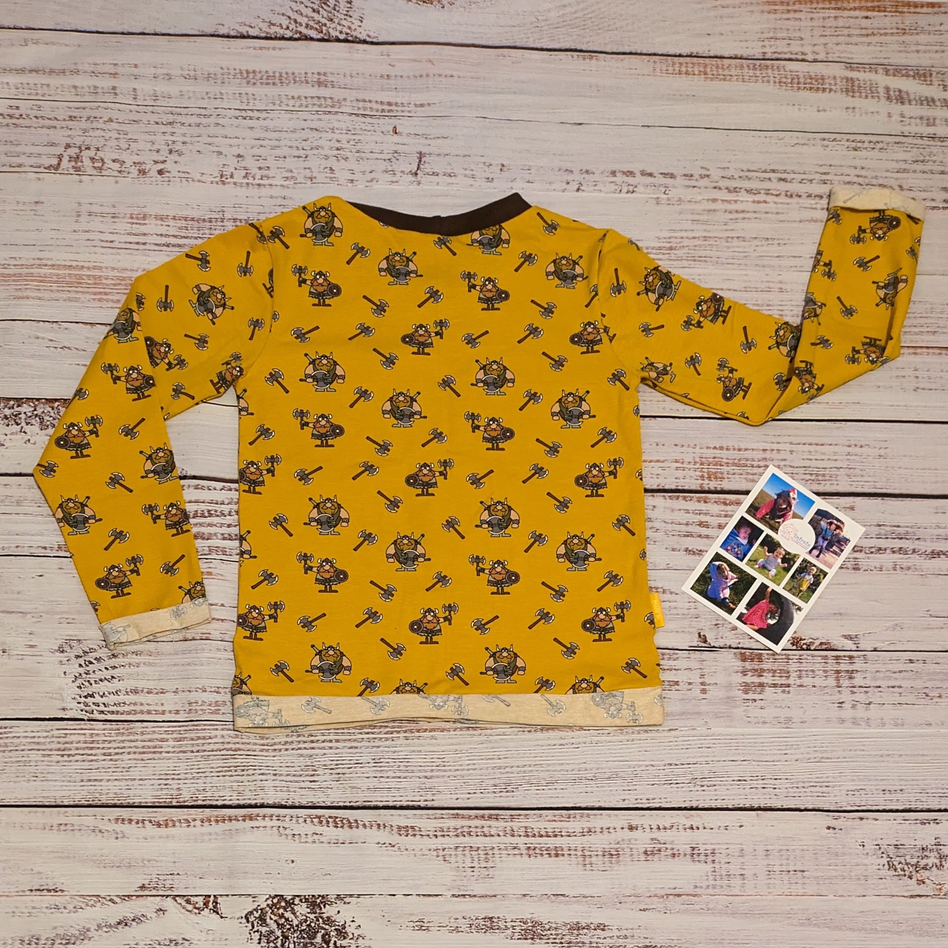 The fearsome mustard Vikings T-shirt. Lovingly handmade using mustard Vikings cotton jersey and chocolate cotton ribbing. Shown with long sleeves from the back.