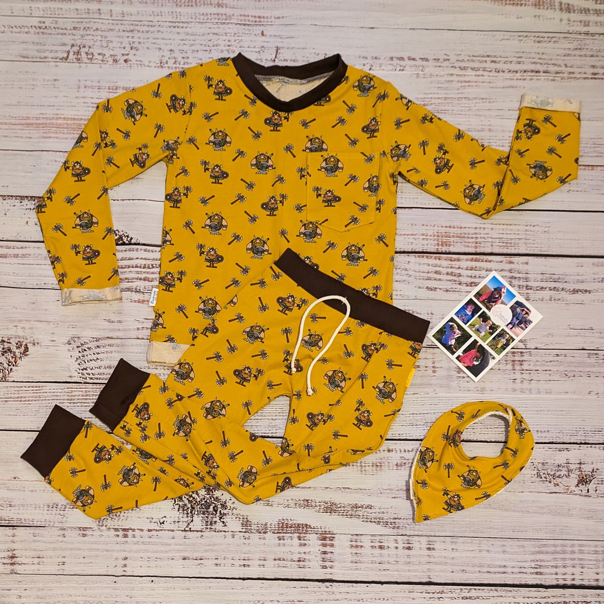 The fearsome mustard Vikings T-shirt. Lovingly handmade using mustard Vikings cotton jersey and chocolate cotton ribbing. Shown with long sleeves, in a set with matching harem joggers and bamboo bib..