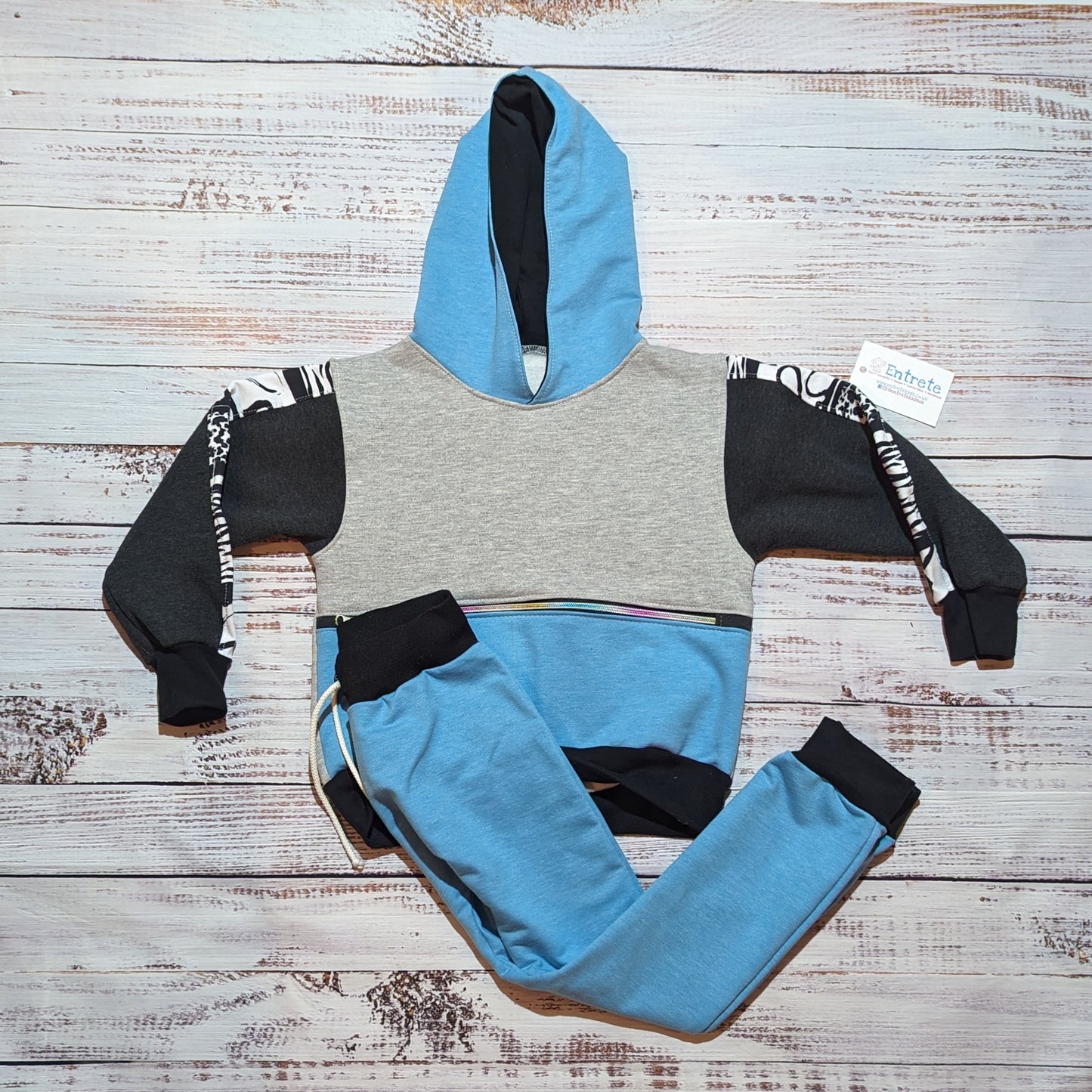Sky blue, grey and animal hearts hoodie, with a zipped front pocket. Handmade using soft and comfortable cotton French terry. Shown as a set with matching sky blue harem joggers.