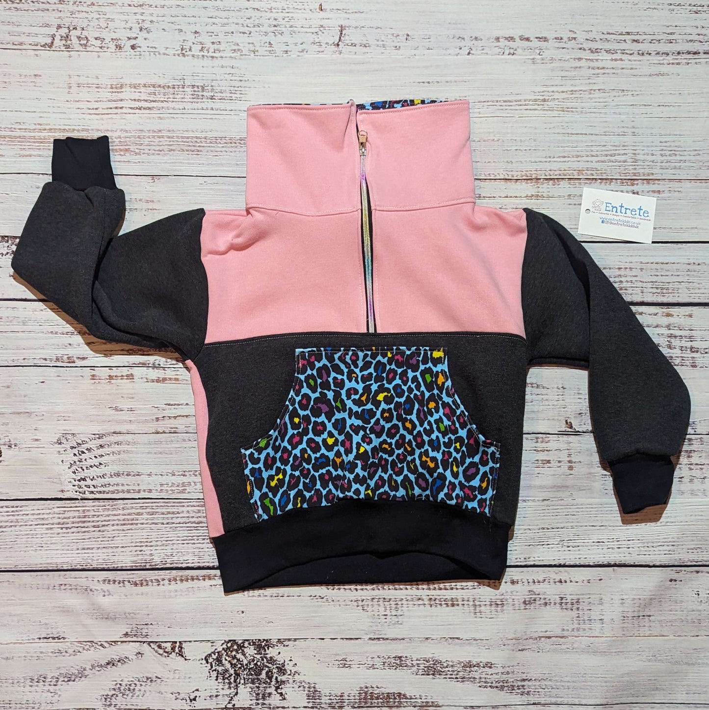 Colourful neon leopard print sweatshirt. Shown with the zipped collar closed.