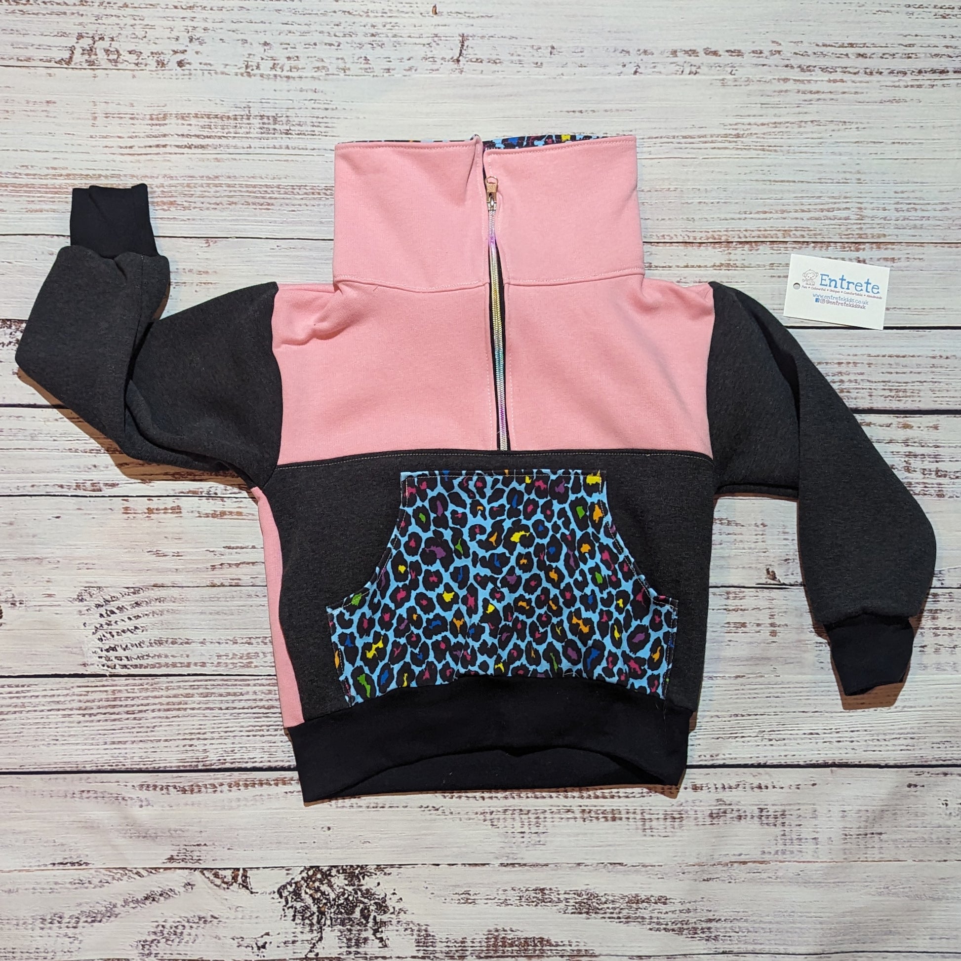 The gorgeous charcoal, pink and neon leopard print zip sweatshirt. With colourful animal print on the front pocket and collar. Shown with the collar closed for warmth.