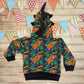 The Colourful and fun skateboarding dinosaur hoodie. Handmade using cool street dino cotton French terry, black cotton Jersey and graphite cotton ribbing. With spines and teeth on the hood and a contrasting front pocket. Shown from the rear.