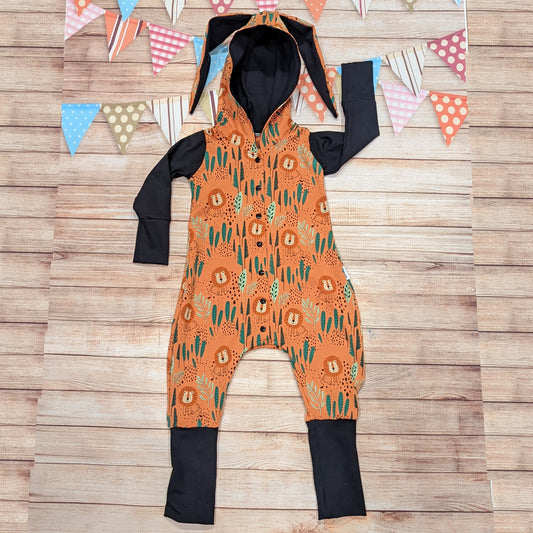 The ferociously fun orange lions bunny romper. Handmade using warm orange lions cotton French terry and black cotton jersey. Featuring front poppers and fun bunny ears on the hood.