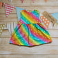 Front of Girls & Babies back popper dress, handmade in bright rainbow stars cotton jersey. Shown in the sleeveless version.