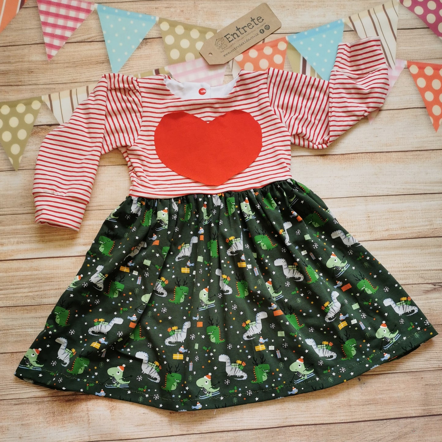Girls Christmas dress, handmade using the brilliant dark green festasaurus cotton jersey and red striped cotton jersey with adorable red heart detailing. A dinosaur fanatics dream!
