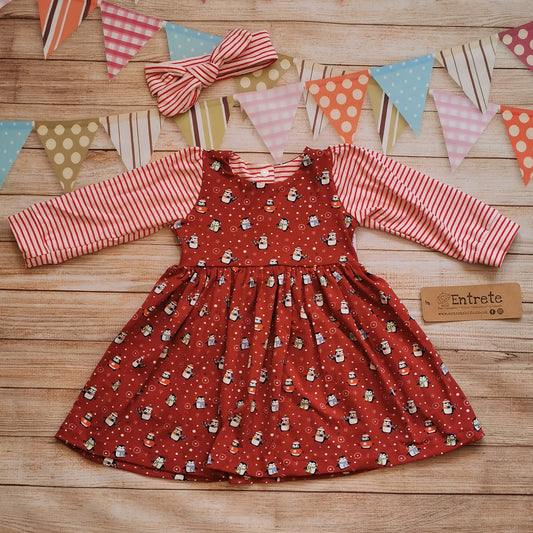 Contrasting girls Christmas dress. Handmade using festive red penguins cotton jersey with contrasting red striped cotton jersey arms. Shown with a red striped headband (sold separately).