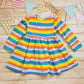 Front view of the colourful red rainbow striped back popper dress.