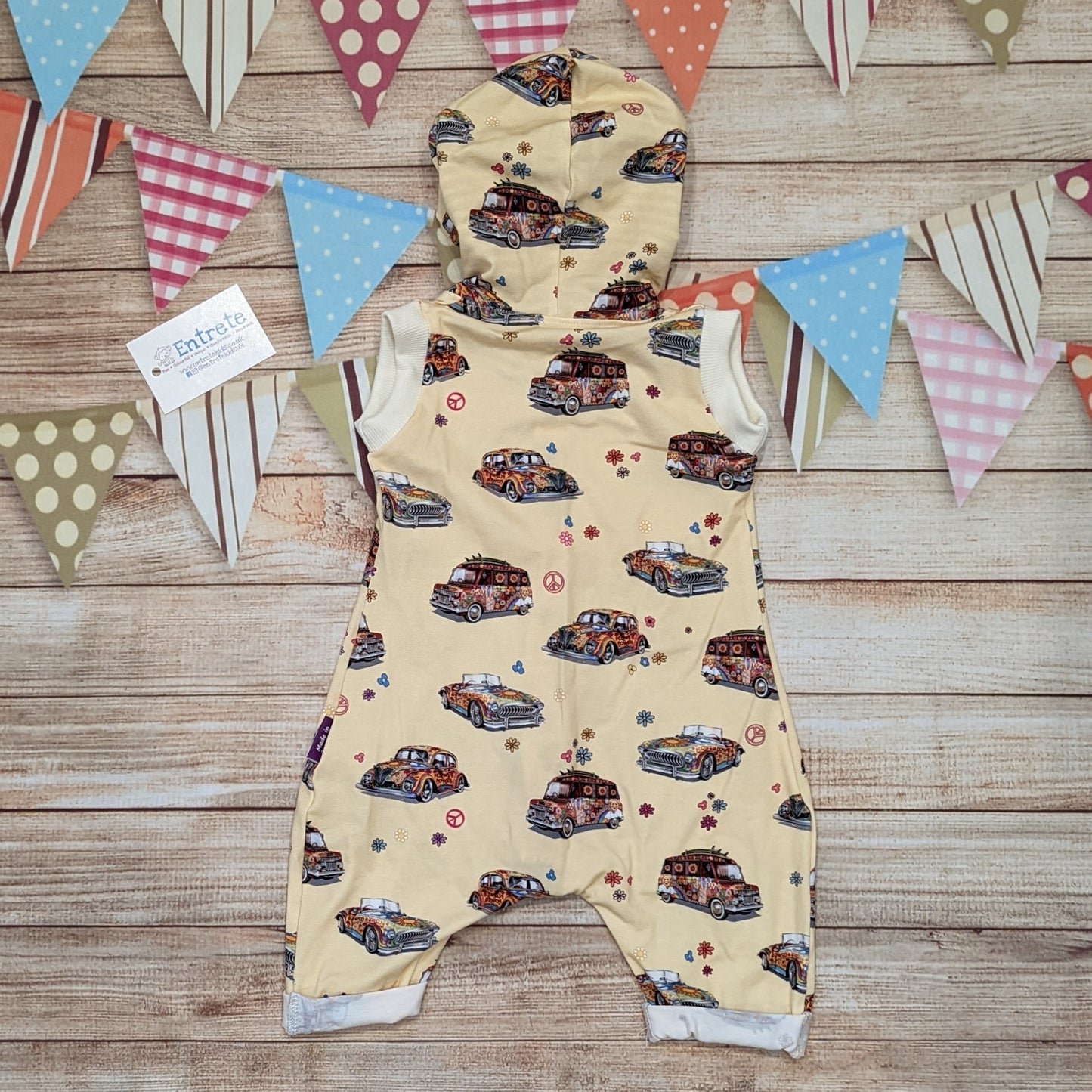 The fun retro hippie cars bummie romper, perfect for your little surf dude this summer. Handmade using light yellow hippie cars and monochrome striped cotton jersey's. Shown from the rear.