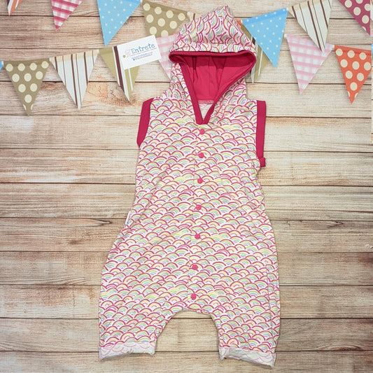 The adorable mini rainbows and fuchsia hooded bummie romper, perfect for the summer. Handmade using mini rainbows on white cotton jersey and fuchsia cotton jersey and cotton ribbing.