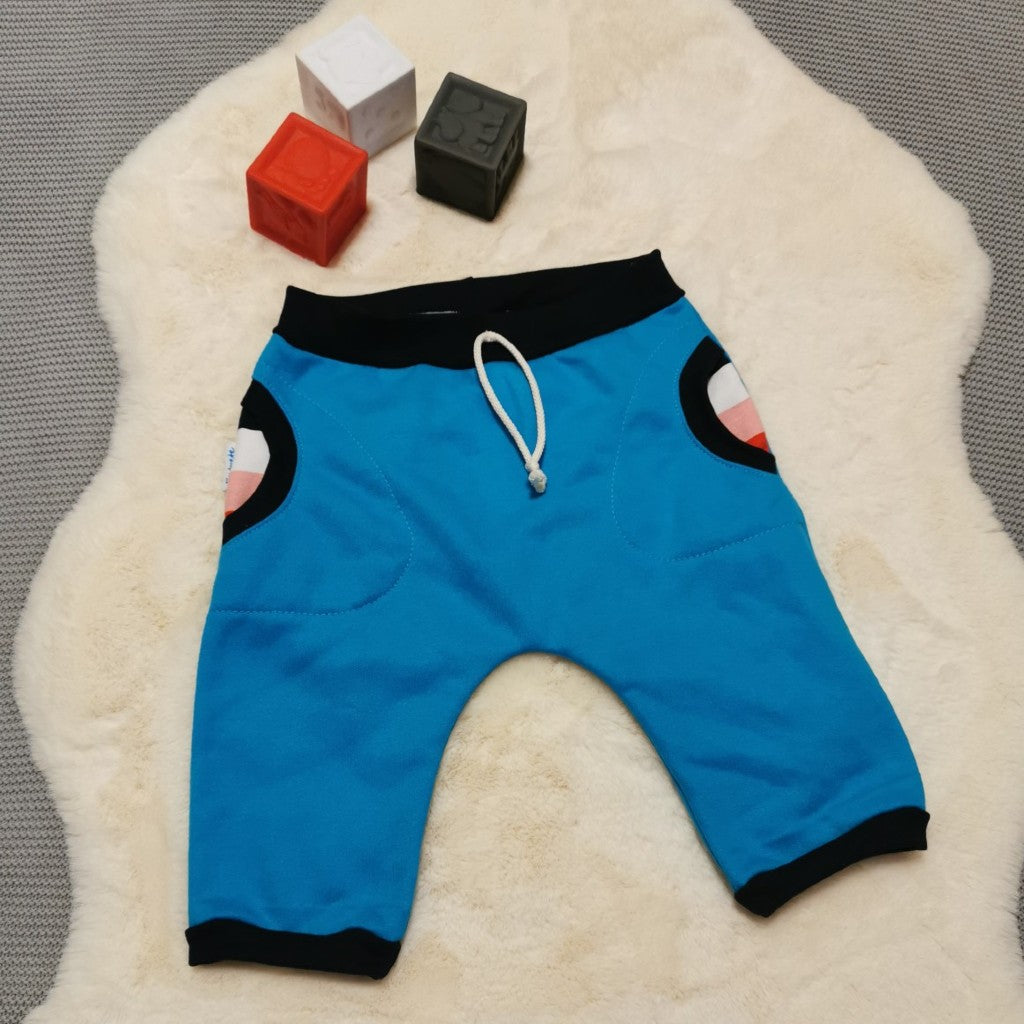 These harem shorts are great for active kids, with elasticated waist, ribbed cuffs and front pockets. Handmade using sky blue sweatshirt fleece, colour striped cotton French terry and navy cotton ribbing.