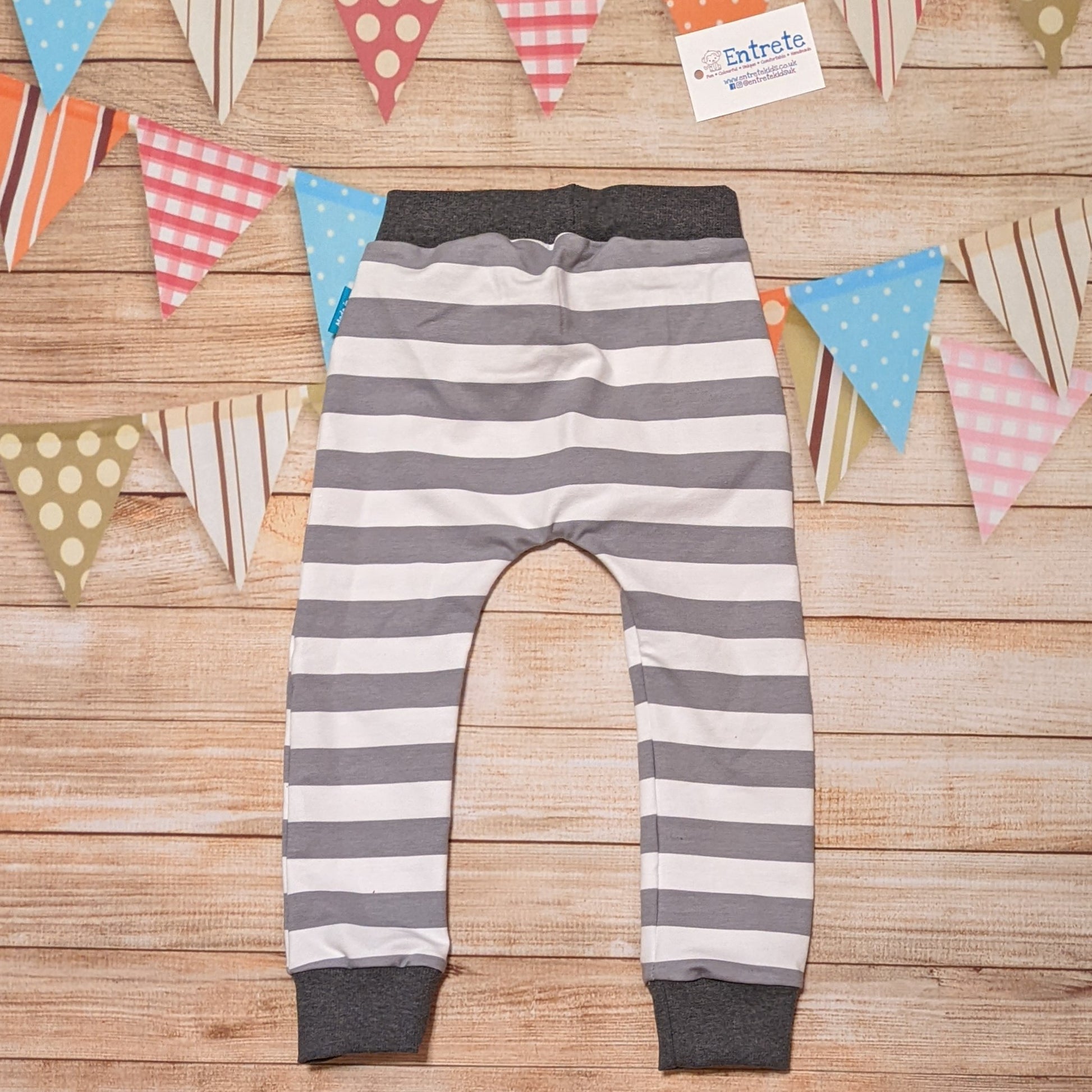 Grey and white striped harem joggers. Handmade with grey striped cotton French terry and graphite cotton ribbing. Shown from the rear.