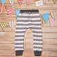 Grey and white striped harem joggers. Handmade with grey striped cotton French terry and graphite cotton ribbing. Shown from the rear.