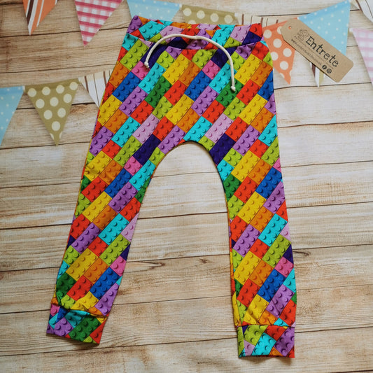 Harem joggers with elasticated waist, dropped crotch and roll-able ankle cuffs. Handmade in colourful Building Blocks cotton jersey.