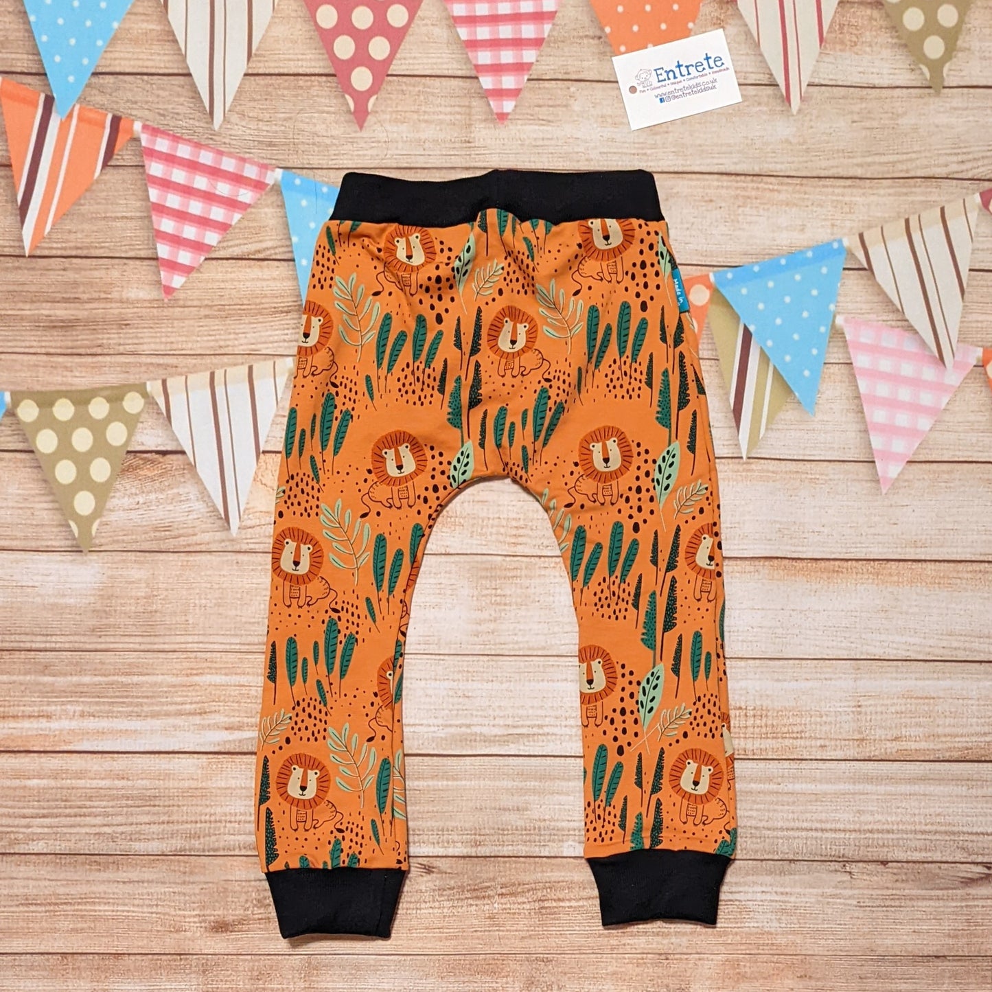 Rear of the fun and ferocious orange Lions harem joggers. Handmade using orange Lions cotton French terry and black cotton ribbing.