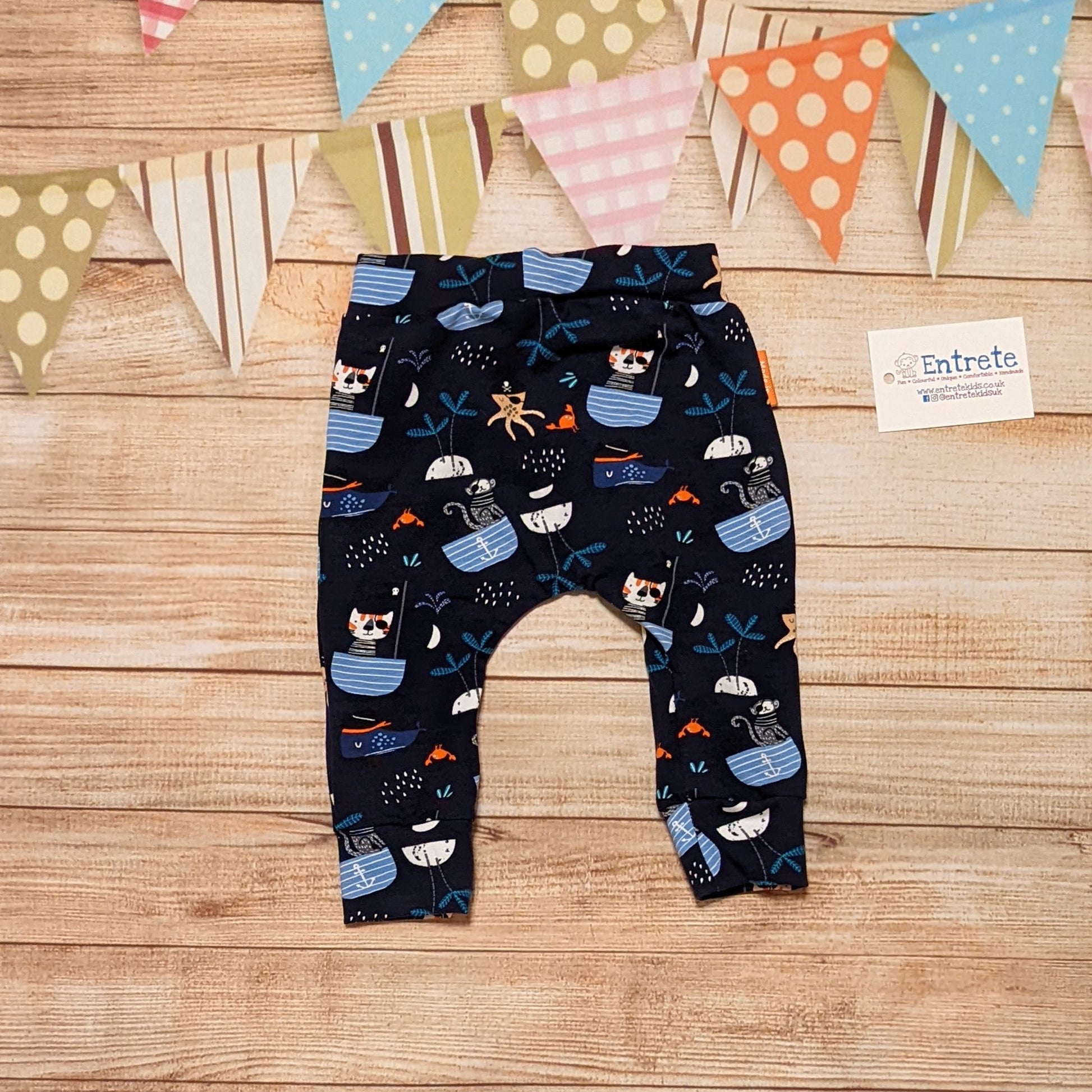 Fun and adventure await, with the pirate cats harem joggers! Shown from the rear. Handmade using pirate cats cotton jersey.