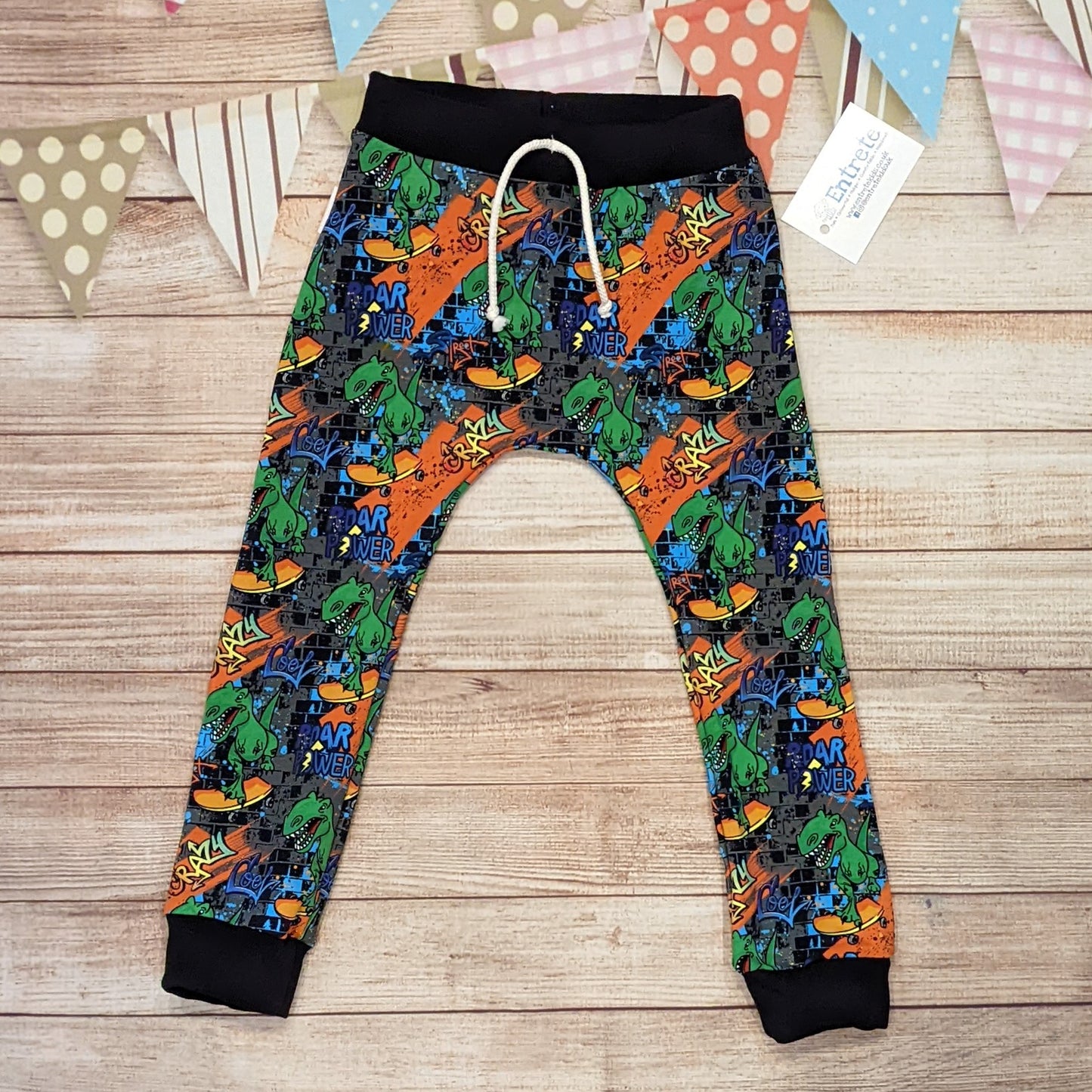 The insanely fun skateboarding dinosaurs harem joggers, handmade using street dino cotton French terry and black cotton ribbing.