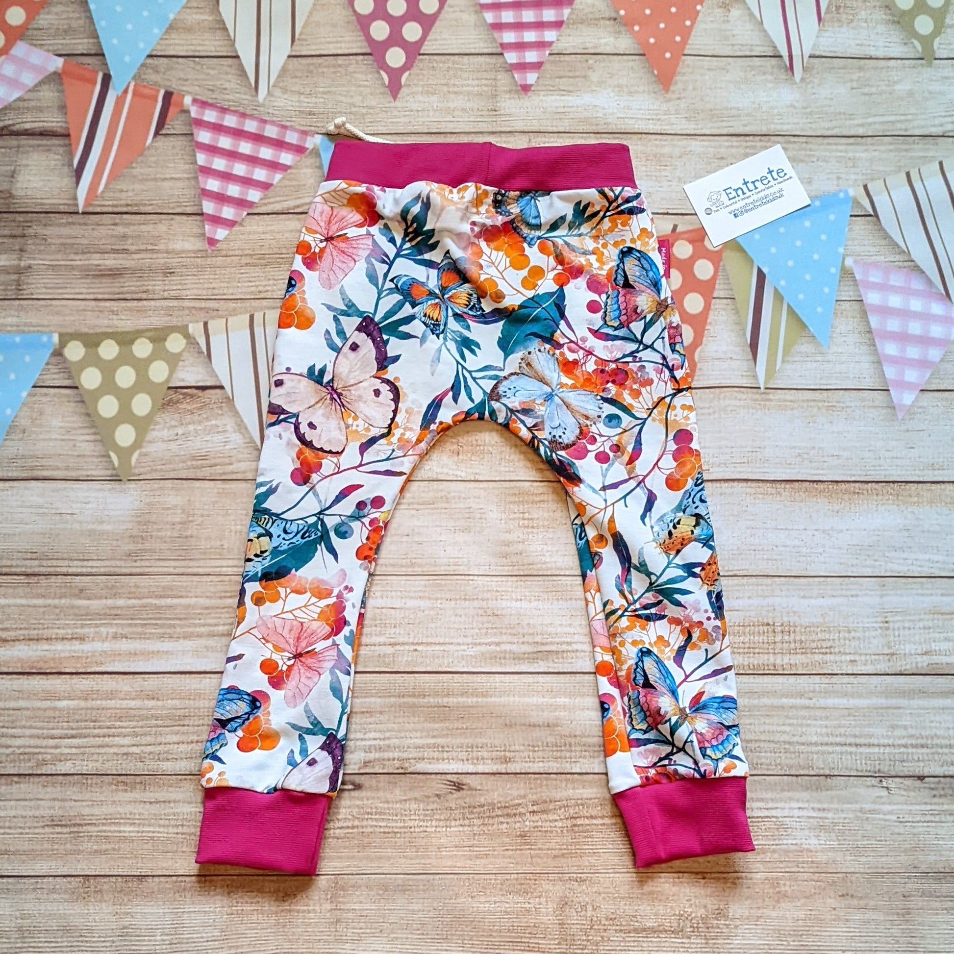 Vibrant butterflies harem joggers, handmade using vibrant butterflies cotton jersey and fuchsia cotton ribbing. Shown from the rear.