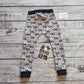 Fun red tractors on grey kids harem joggers. Handmade using grey tractors cotton jersey and black cotton ribbing. Shown from the rear.