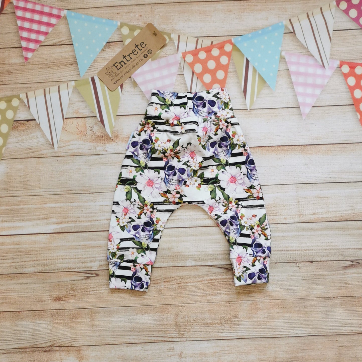Rear view of the soft, comfortable harem pants with a non-elasticated waistband, perfect for younger children. Handmade using the gorgeously gothic skulls and flowers cotton jersey.