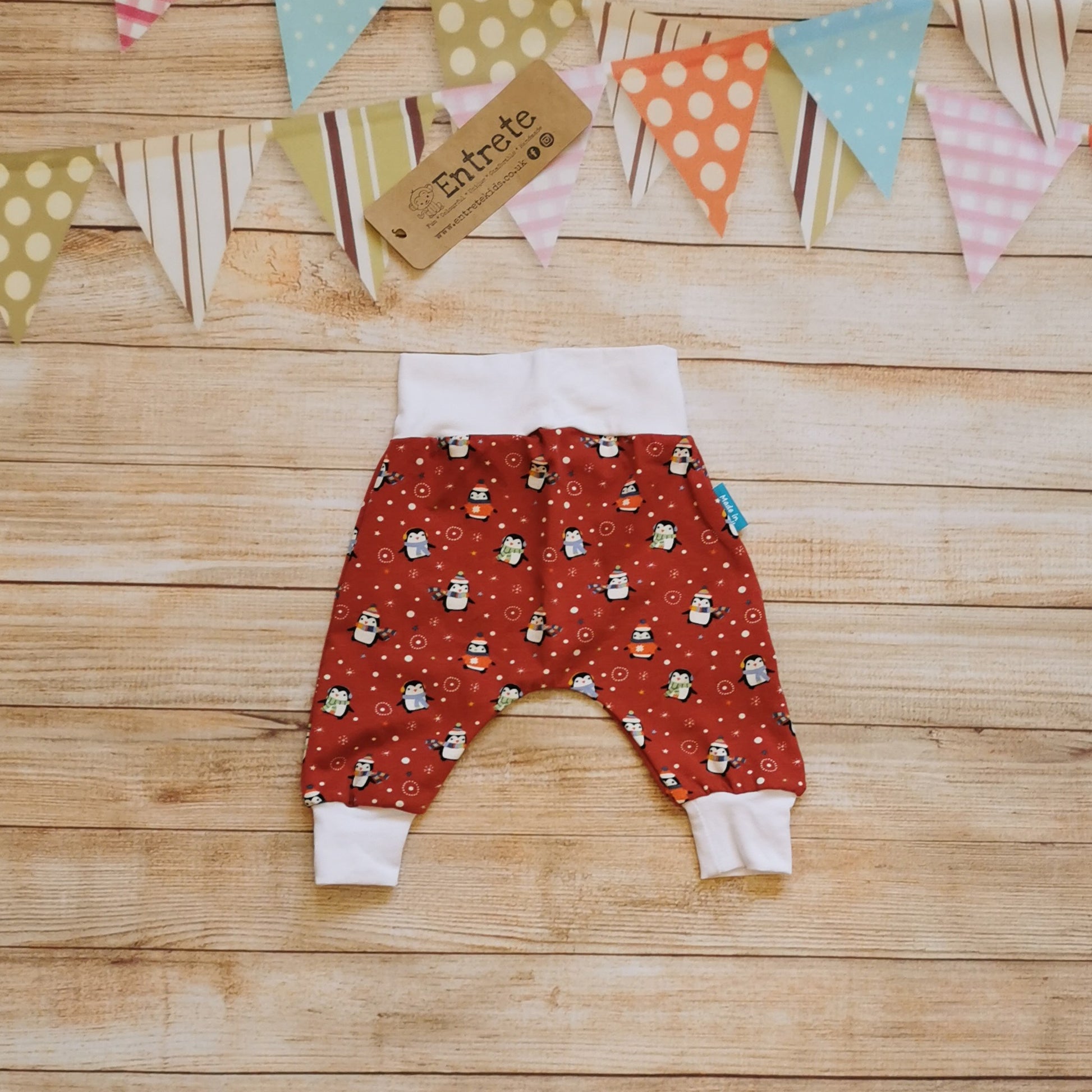 Rear view of the super comfy harem pants in a fun Christmas design. Handmade using red penguins cotton jersey and white cotton jersey.