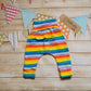Rear of colourful red rainbow striped harem pants. With rollable ankle cuffs, dropped crotch and non-elasticated waist.