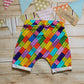 Rear view of colourful building bricks harem shorts.