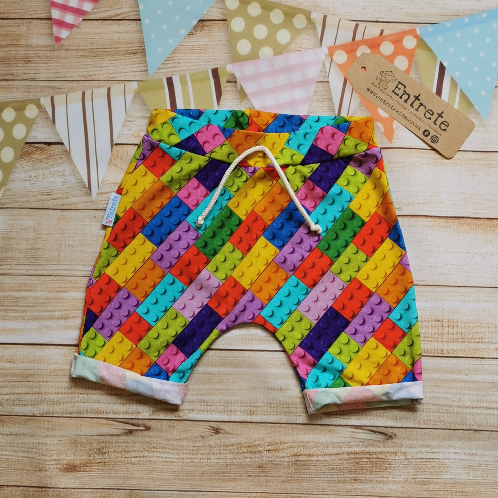 Kids harem shorts, handmade using colourful building block cotton jersey. Featuring elasticated waist, rolled ends and lowered crotch.