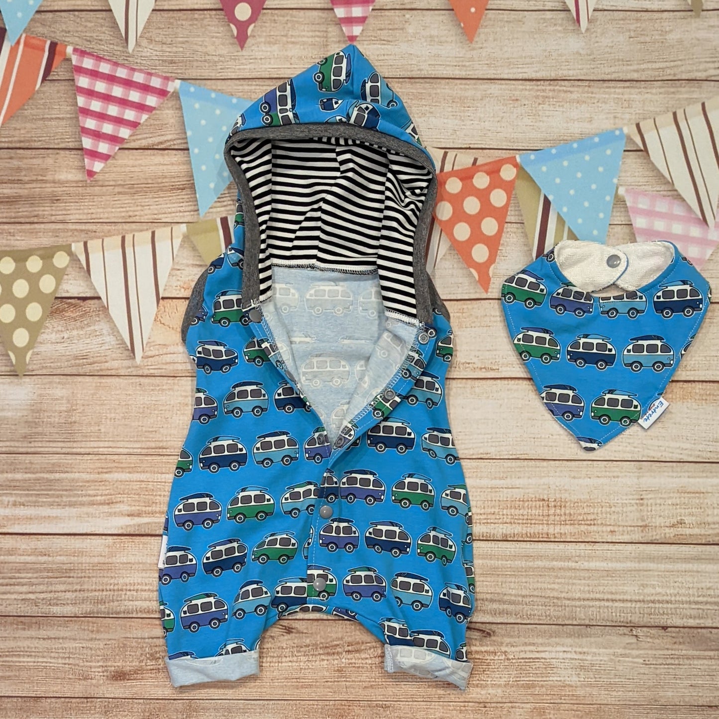 The epic blue surf campervan bummie romper. Handmade using blue surf campervan and monochrome striped cotton jersey's with graphite cotton ribbing. Shown open and with a matching bamboo bib.